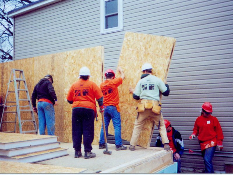 Habitat volunteers installing Thermapan SIP panels