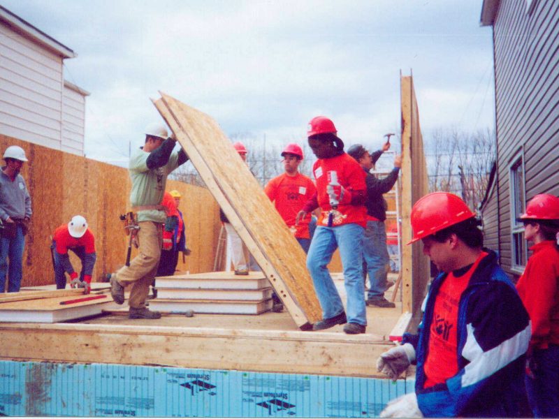 Habitat volunteers installing Thermapan SIP panels